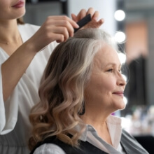 Older woman getting hair done, on-site salon