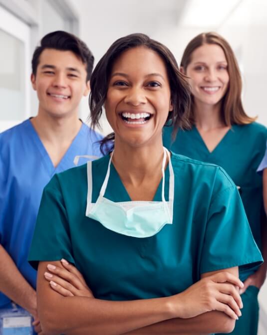Three healthcare workers, smiling