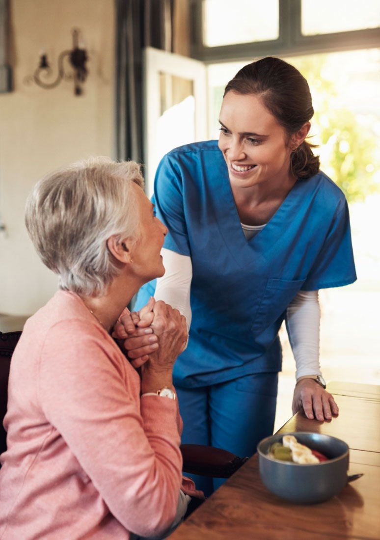 Female caregiver supporting older woman, supportive care